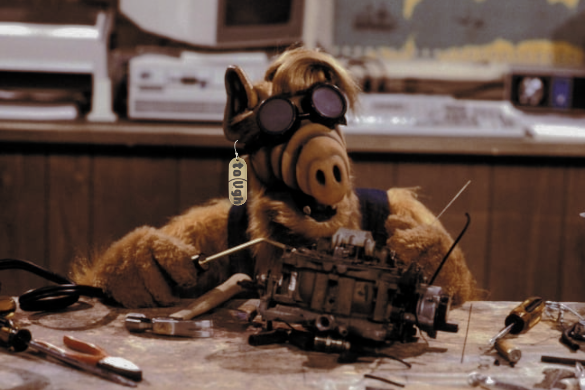 An Alien Life Form in their workshop. Wearing Creative Dexterity's toUGH Pill dangle earrings.