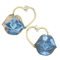 Heart-shaped earrings with blue and gold design lips on a white background