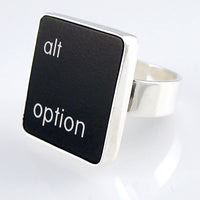 A silver ring featuring a black vertical rectangle with the words 'alt option' printed in white lowercase text, photographed on a clean white background.