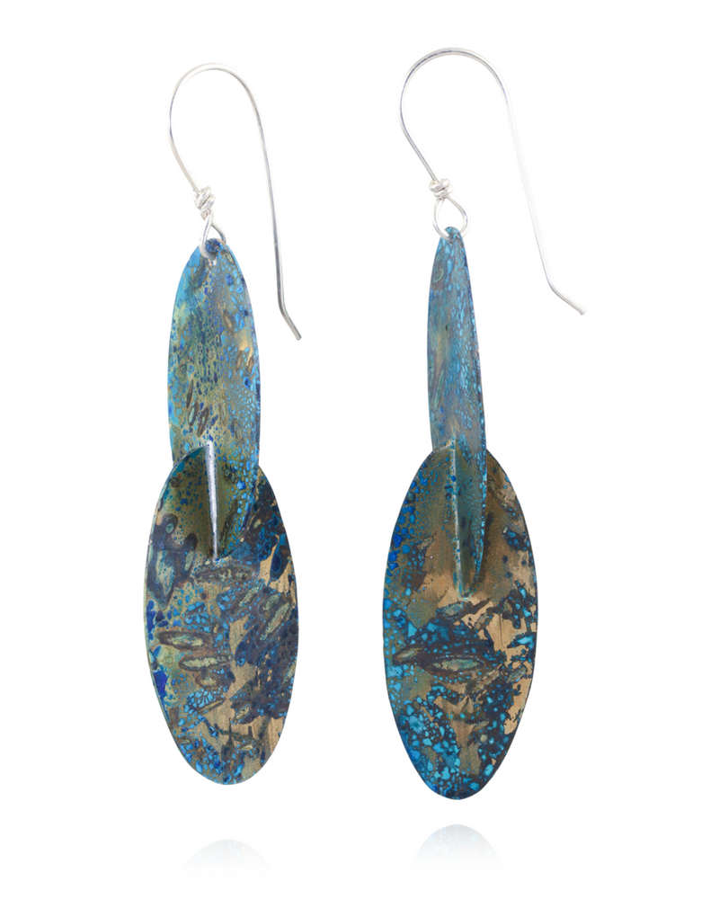 Pair of earrings with blue and gold confetti design on a white background
