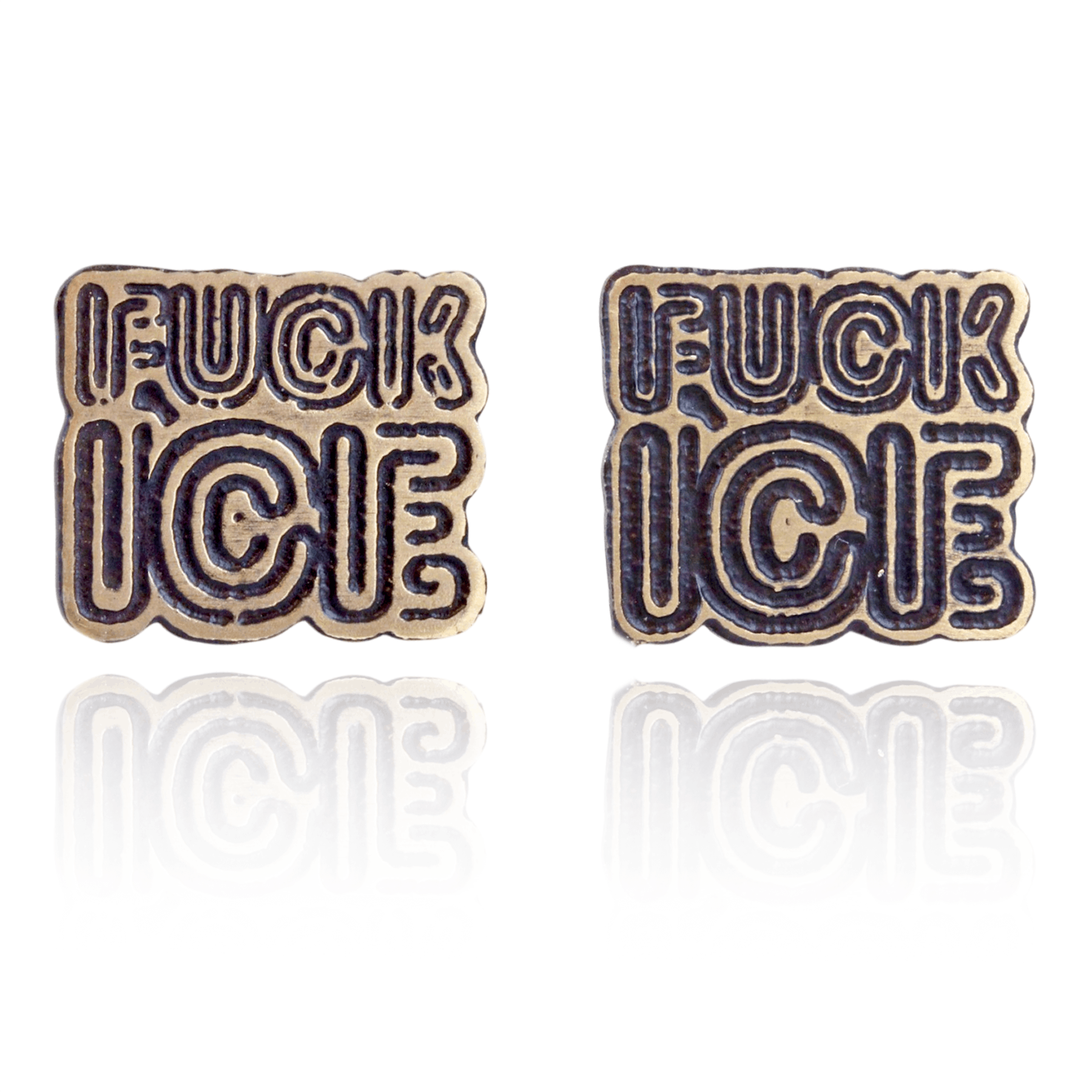 Two metallic 'FUCK ICE' pins on a white background. Front View