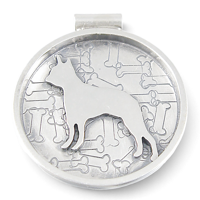 A round silver-toned metal pendant featuring a raised dog silhouette over an embossed pattern of bones, shown on a plain white background.