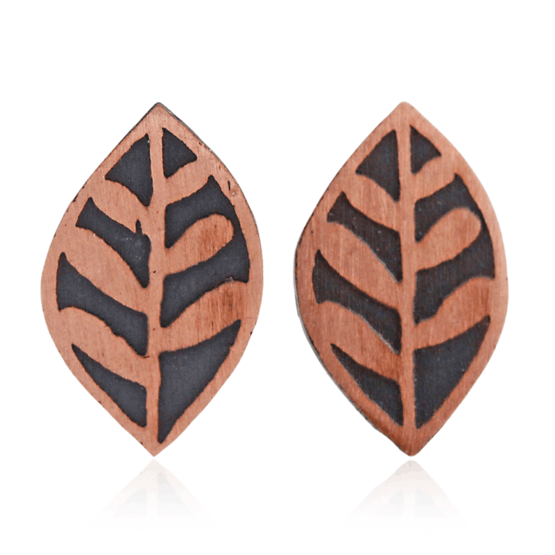 Pair of copper leaf-shaped earrings with black patterns on a white background