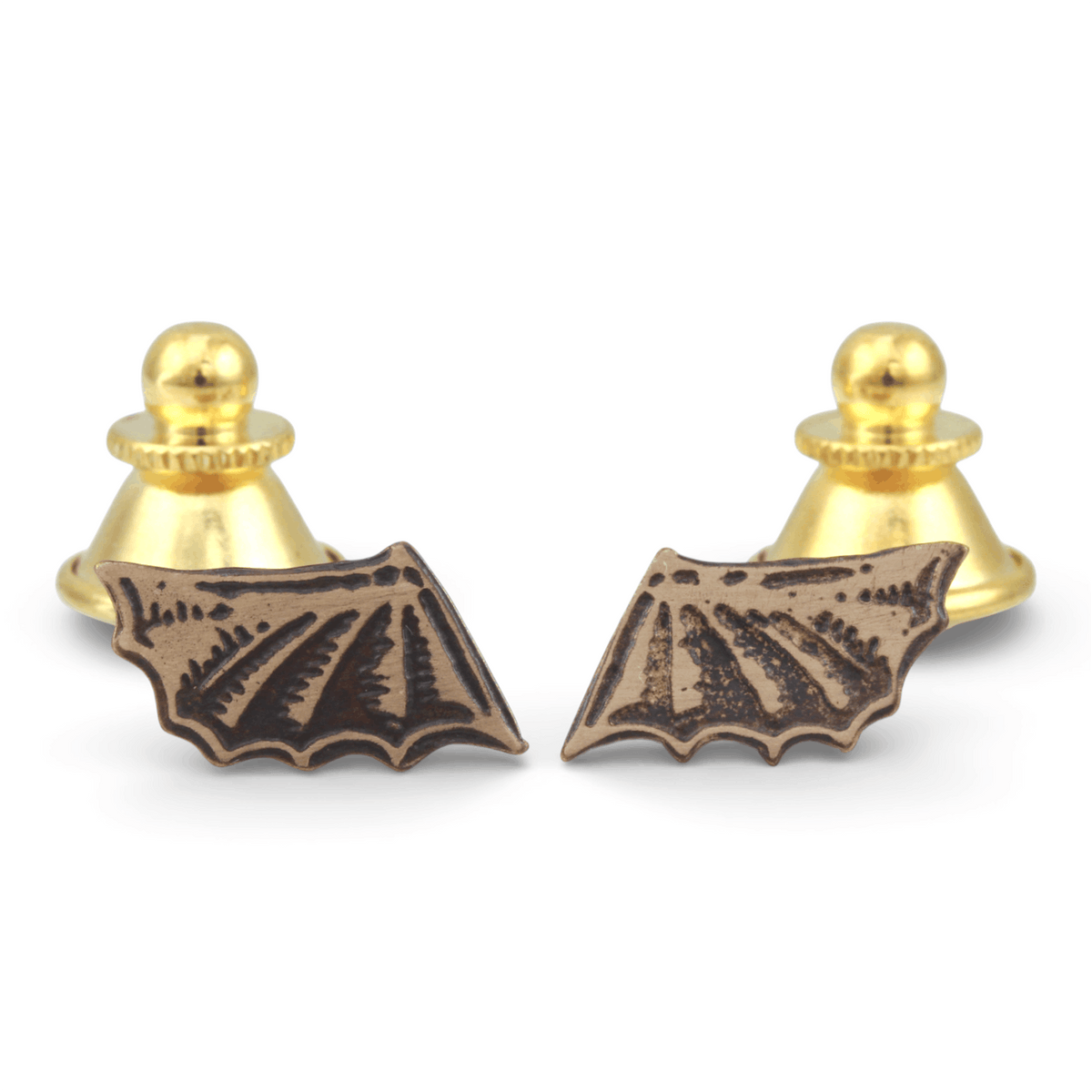 Brass Bat-shaped pin on a white background