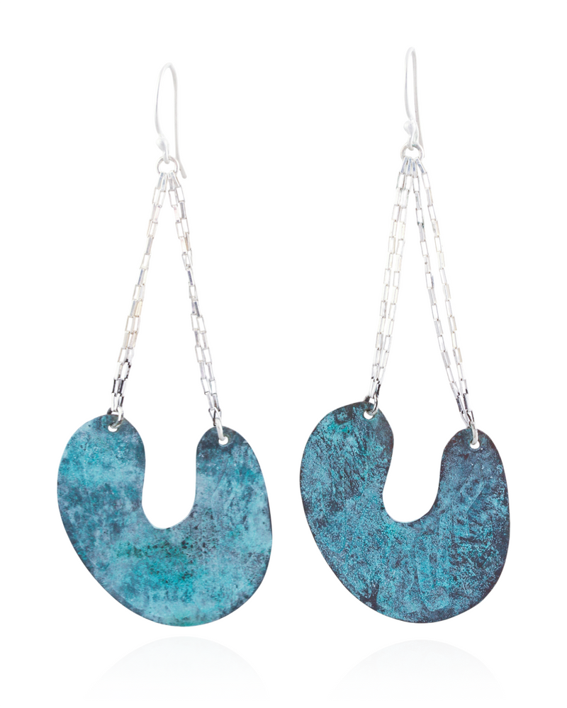 Pair of blue earrings with silver chains on a white background