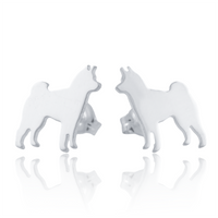 A pair of silver stud earrings shaped like standing Shiba Inu dogs, shown on a white background with a soft reflection below.