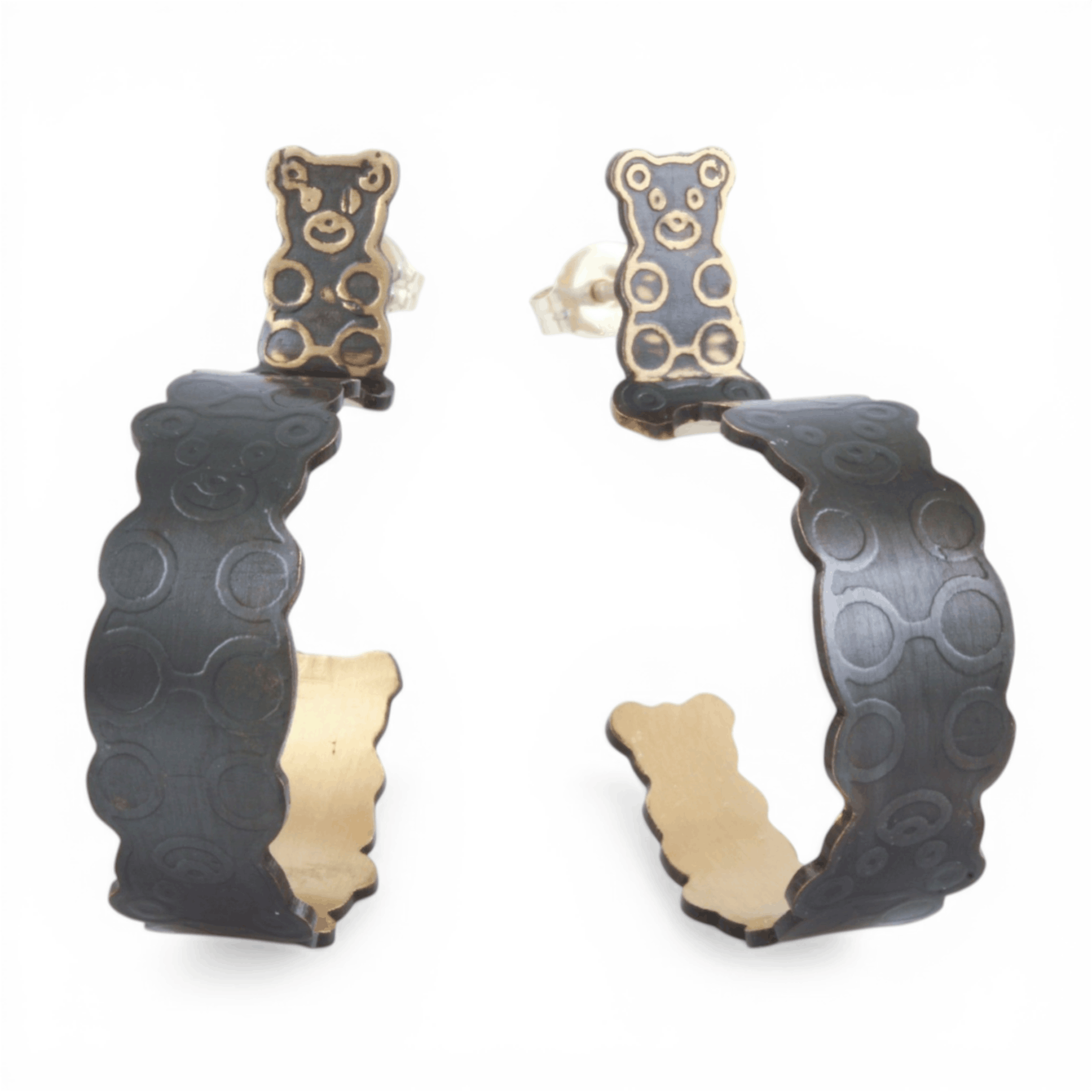 Black and gold hoop earrings with a interlocked teddy bear pattern on a white background.