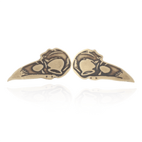 Pair of gold bird skull earrings on a white background