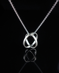 Absolute Cycle - Geometric Orb Pendant by Creative Dexterity - suspended on chain with shadow in background. 