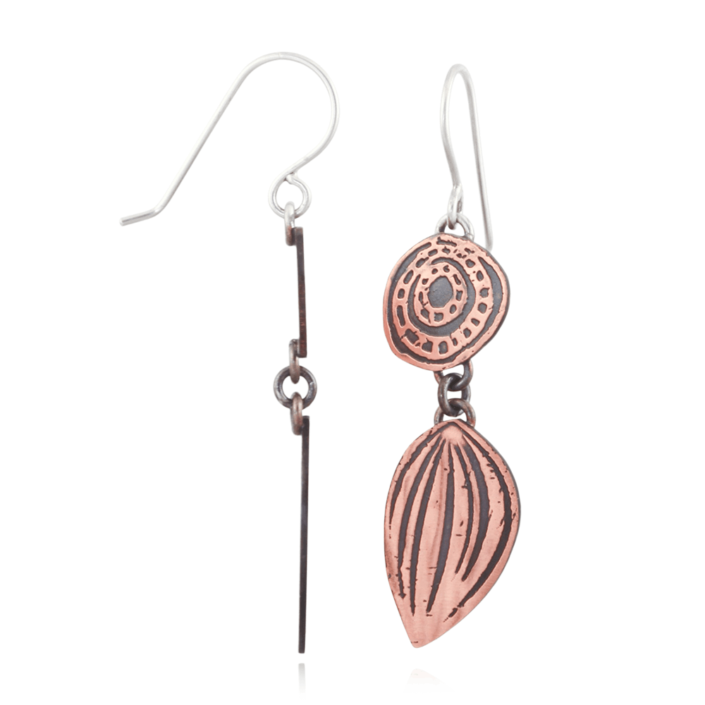 Copper and silver earrings on a white background