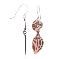 Copper and silver earrings on a white background
