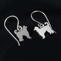 Sterling silver Afghan Hound dangle earrings with hand-sawed dog silhouettes and polished finish on white background.