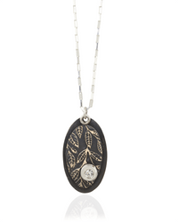 Necklace with an oval pendant featuring leaf patterns and white cubric zirconia gemstone on a white background