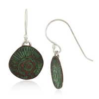 Pair of earrings with green circular designs on a white background