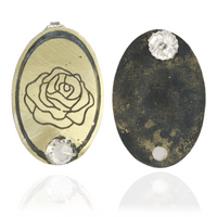 Nu gold pair of oval shaped earrings with rose design and rose quartz gemstone on a white background