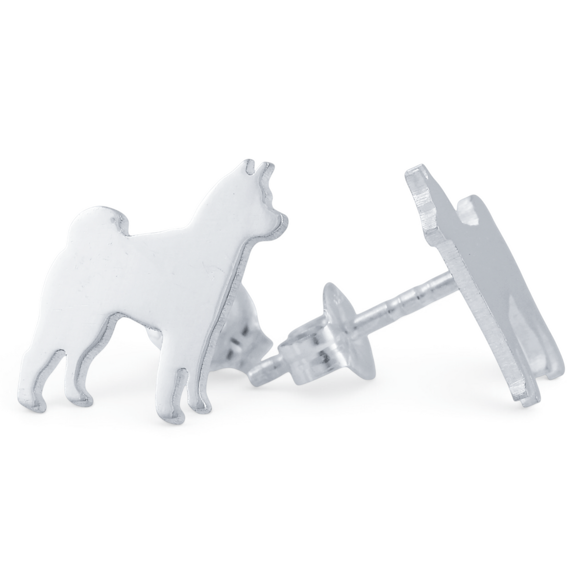 A pair of silver stud earrings shaped like standing Shiba Inu dogs, shown on a white background with a soft reflection below.
