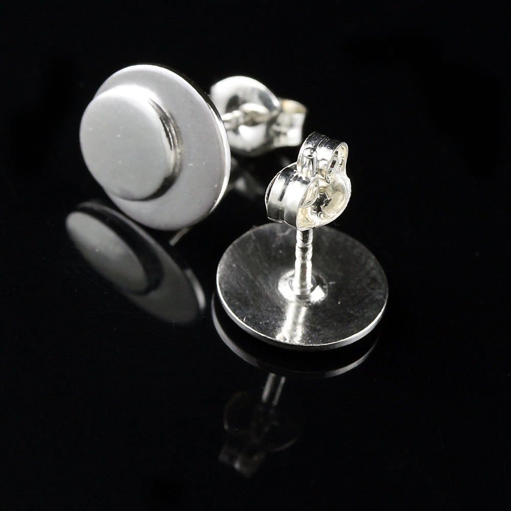 Sterling silver polka dot button earrings on a black background.