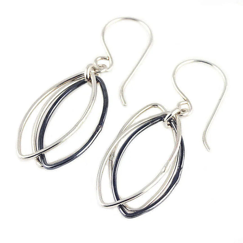 Two-toned abstract leaf dangle earrings in sterling silver, featuring oxidized and polished elements. V2