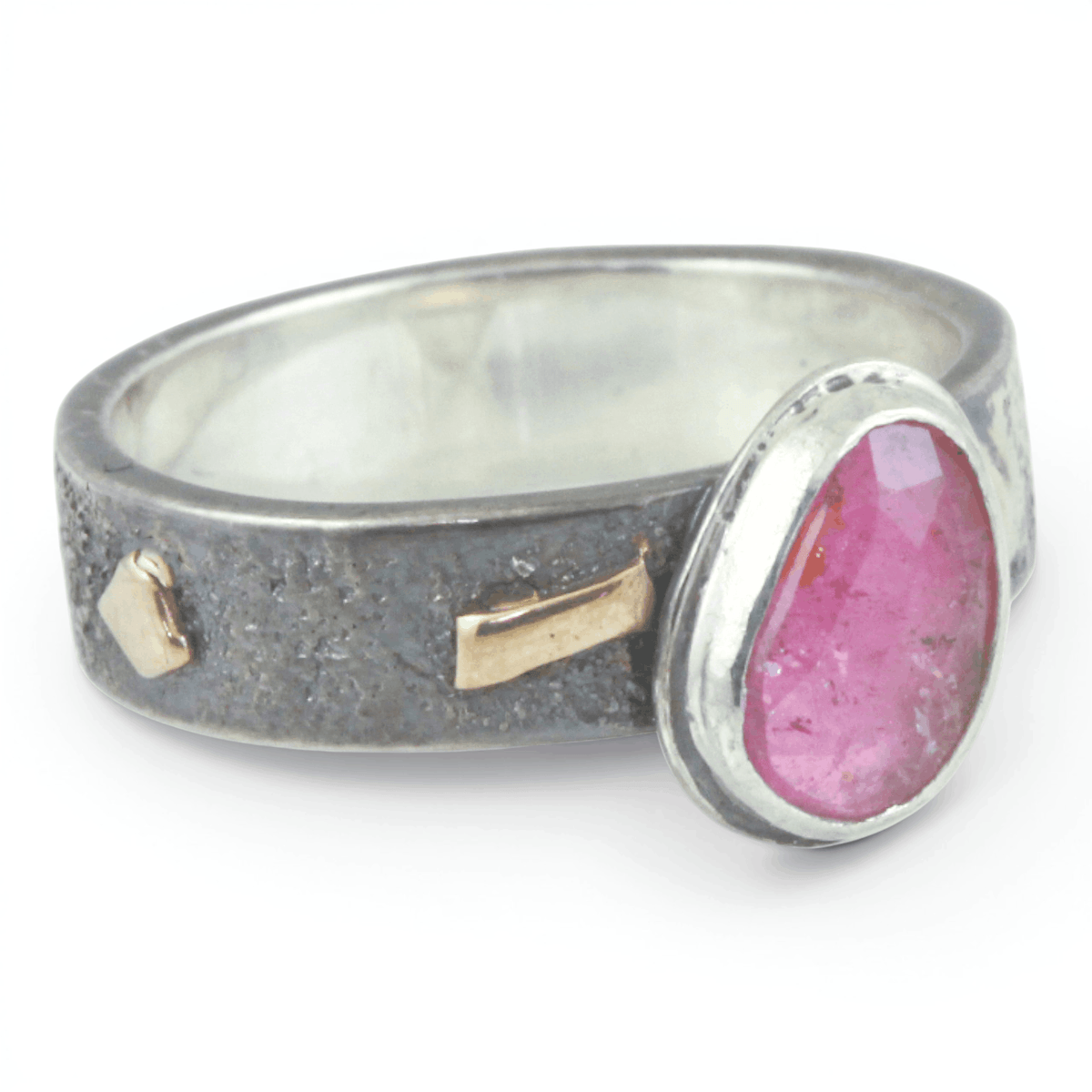 Silver ring with gold and a pink stone on a white background