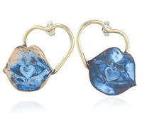 Heart-shaped earrings with blue lips and gold design on a white background