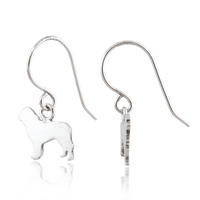 A pair of silver fishhook drop earrings, one showing a polished silhouette charm of a dog and the other showing the side profile of the earring, on a white background with a soft reflection.