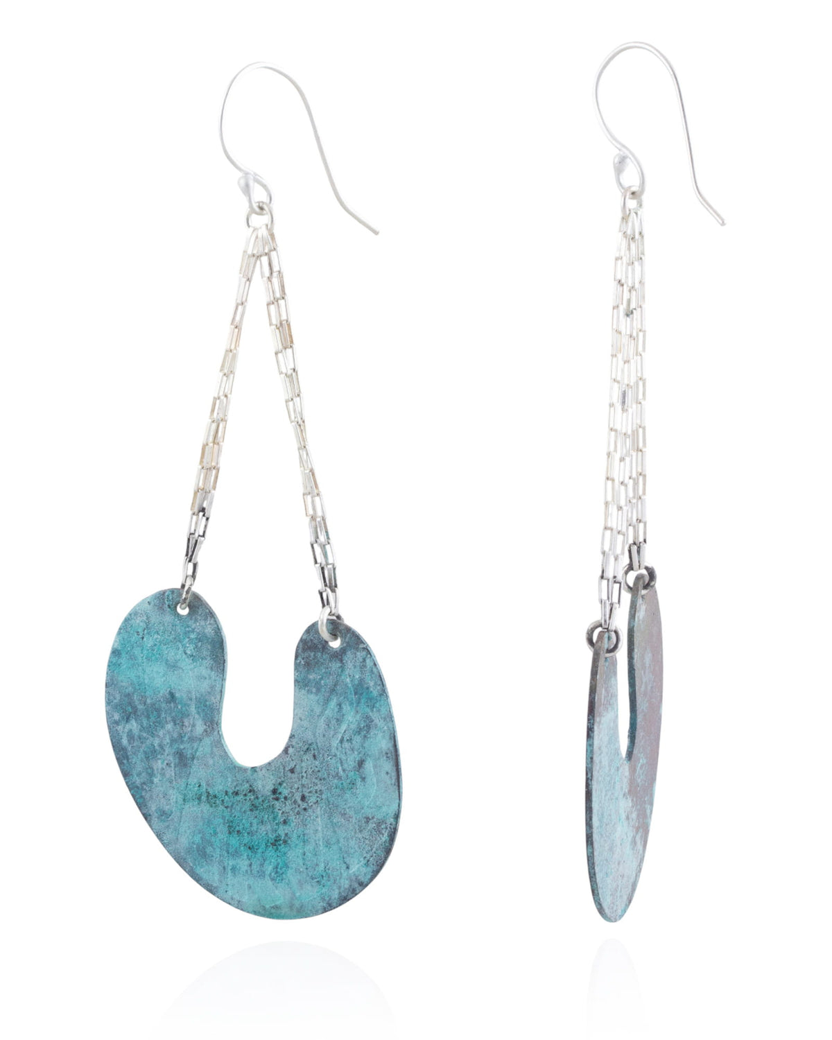 Pair of earrings with blue curved pendant and silver chain on a white background