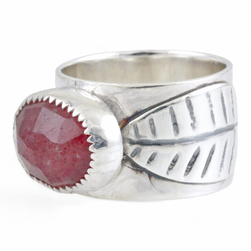 Silver ring with a pink stone and leaf design on a white background
