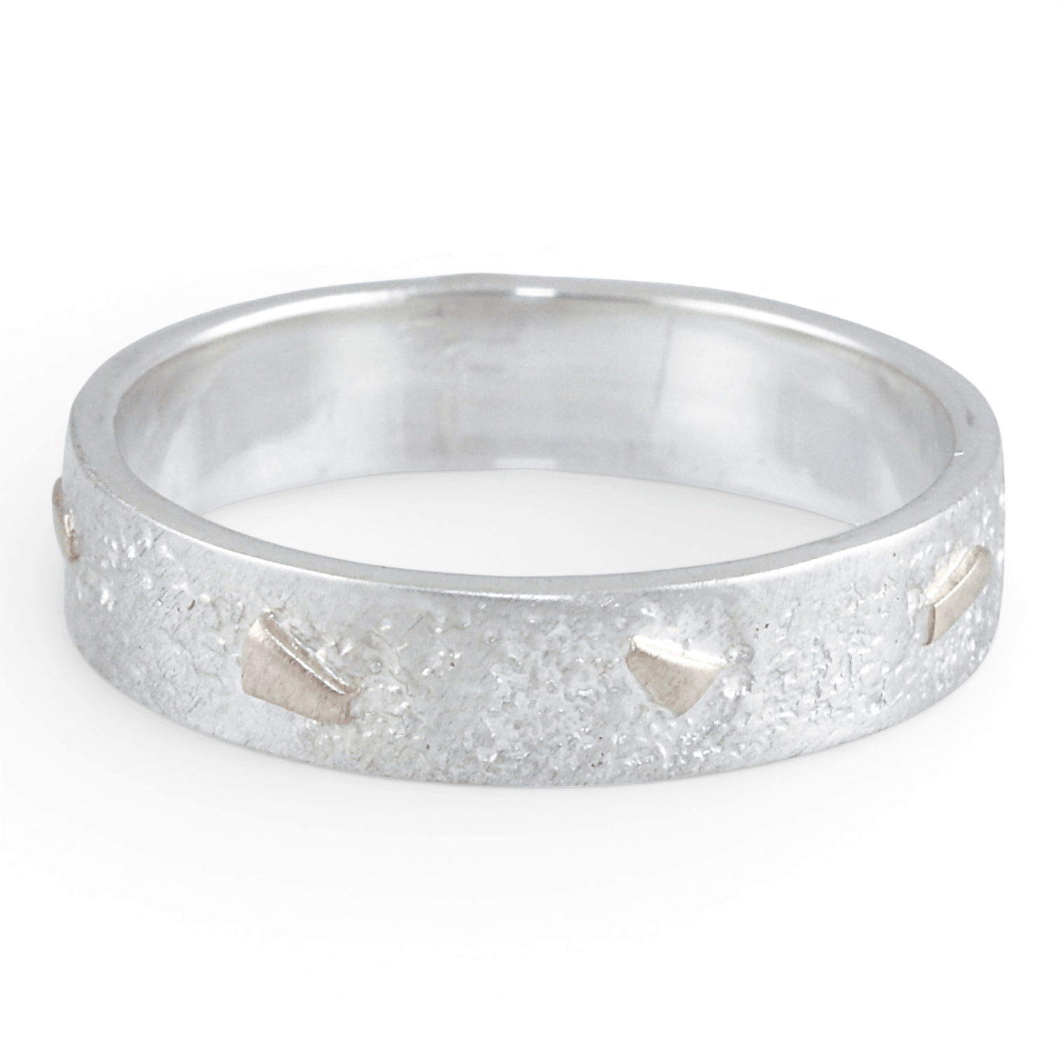 Silver ring with a textured gold surface on a white background