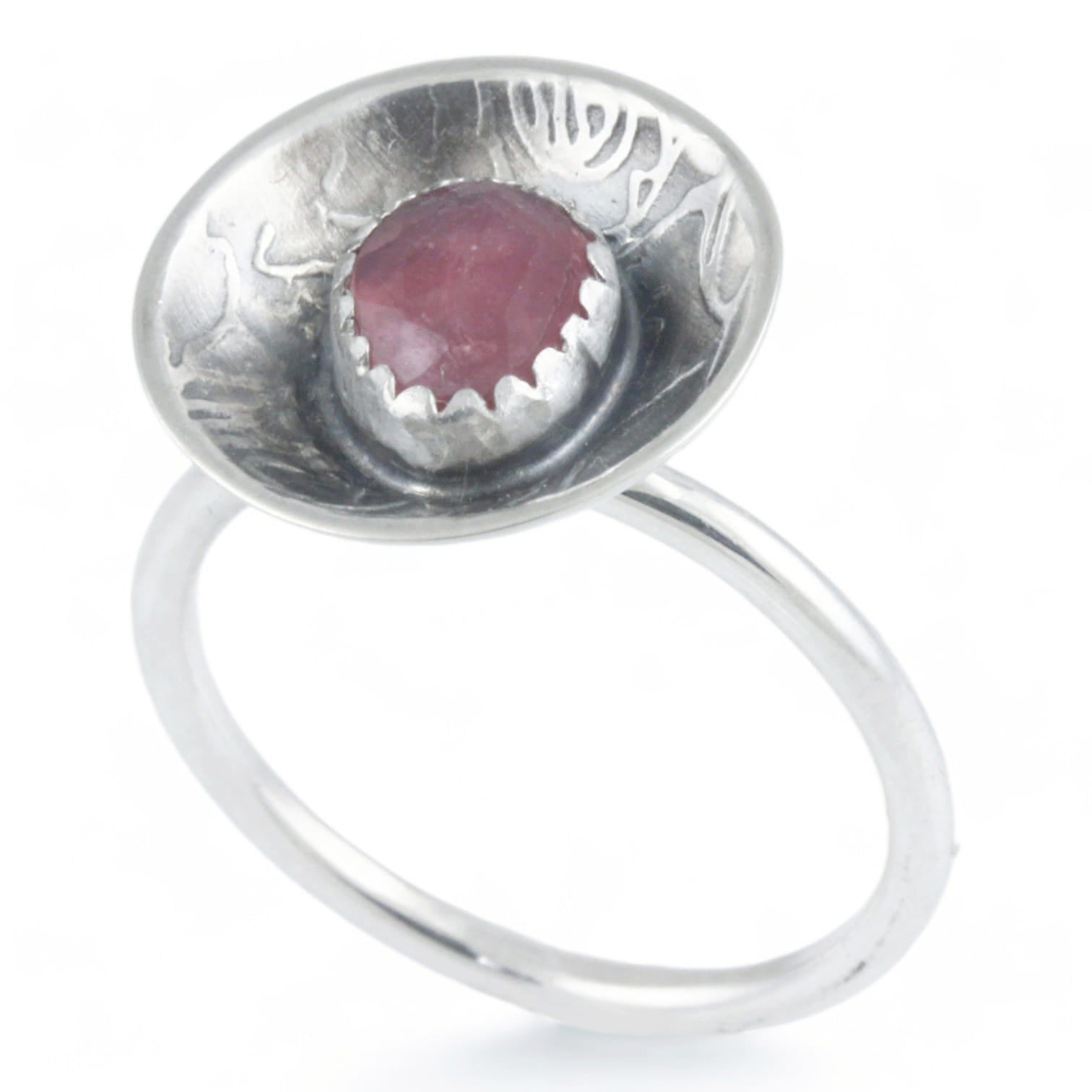 Silver dome ring with a pink gemstone on a white background