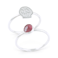 Two silvers ring together, featuring one with a pink gemstone and the other with an engraved skull motif, set against a clean white background.