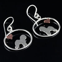 Bichon Frise dangle earrings with sterling silver silhouette and small copper heart in oval frame on black reflective background