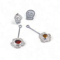 Skull Stud Earrings with Kinetic Tourmaline Wildfower - Laying Front View