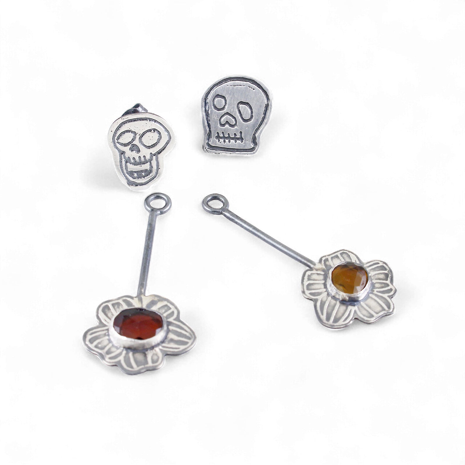 Skull Stud Earrings with Kinetic Tourmaline Wildfower - Laying Front View