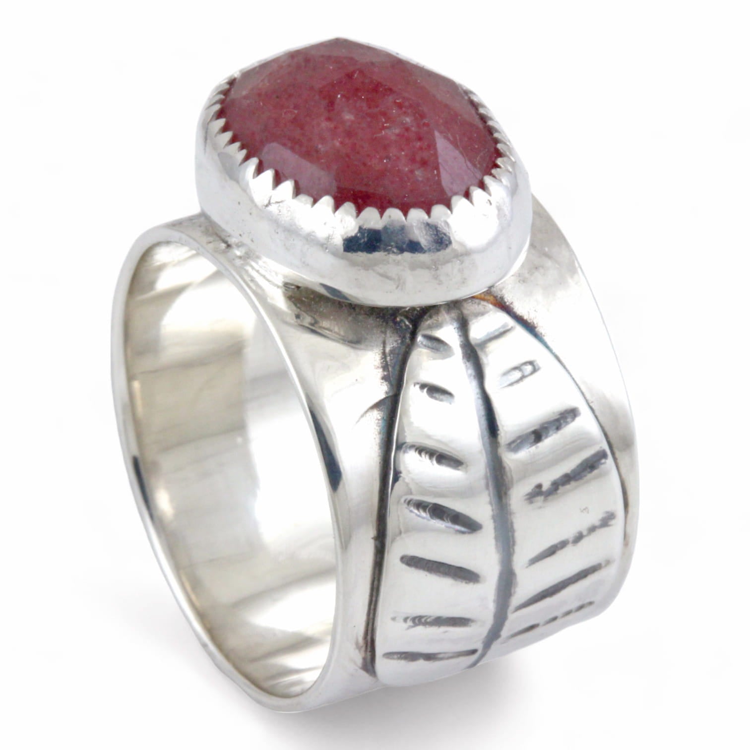 Silver ring with a pink stone and leaf design on a white background