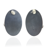 Back of oval pair of earrings on a white background.