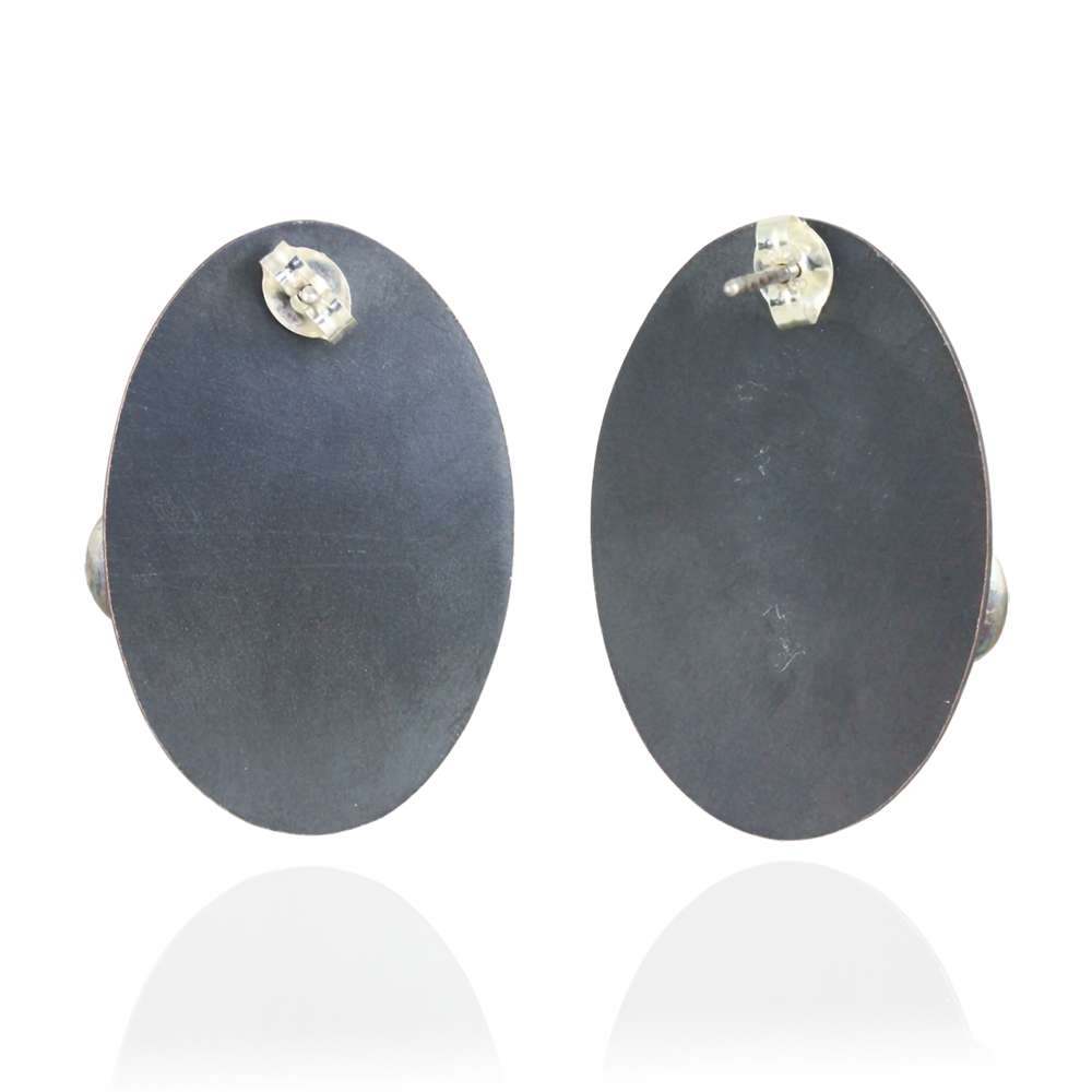 Back of oval pair of earrings on a white background.