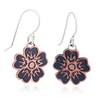 Floral-patterned copper earrings on a white background