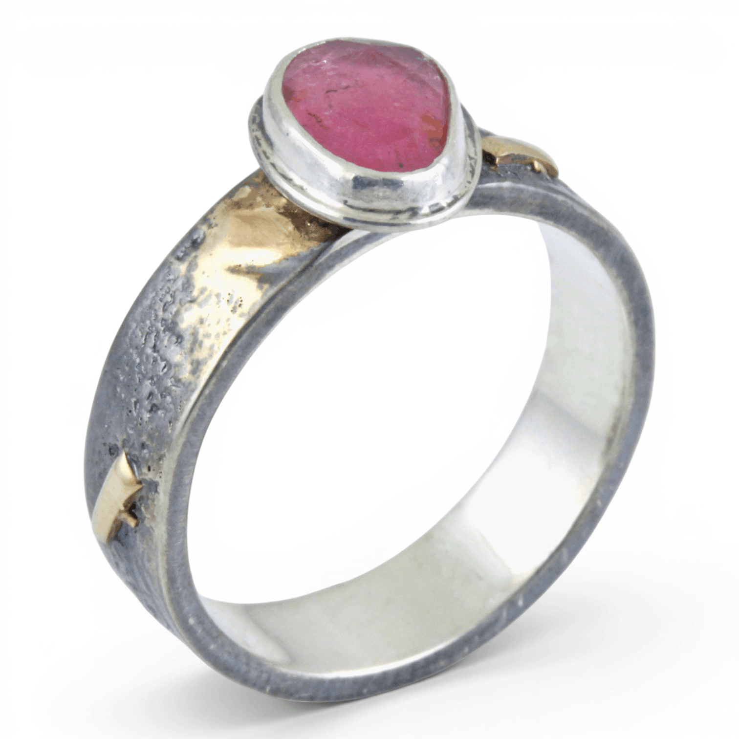 Silver ring with gold and a pink stone on a white background