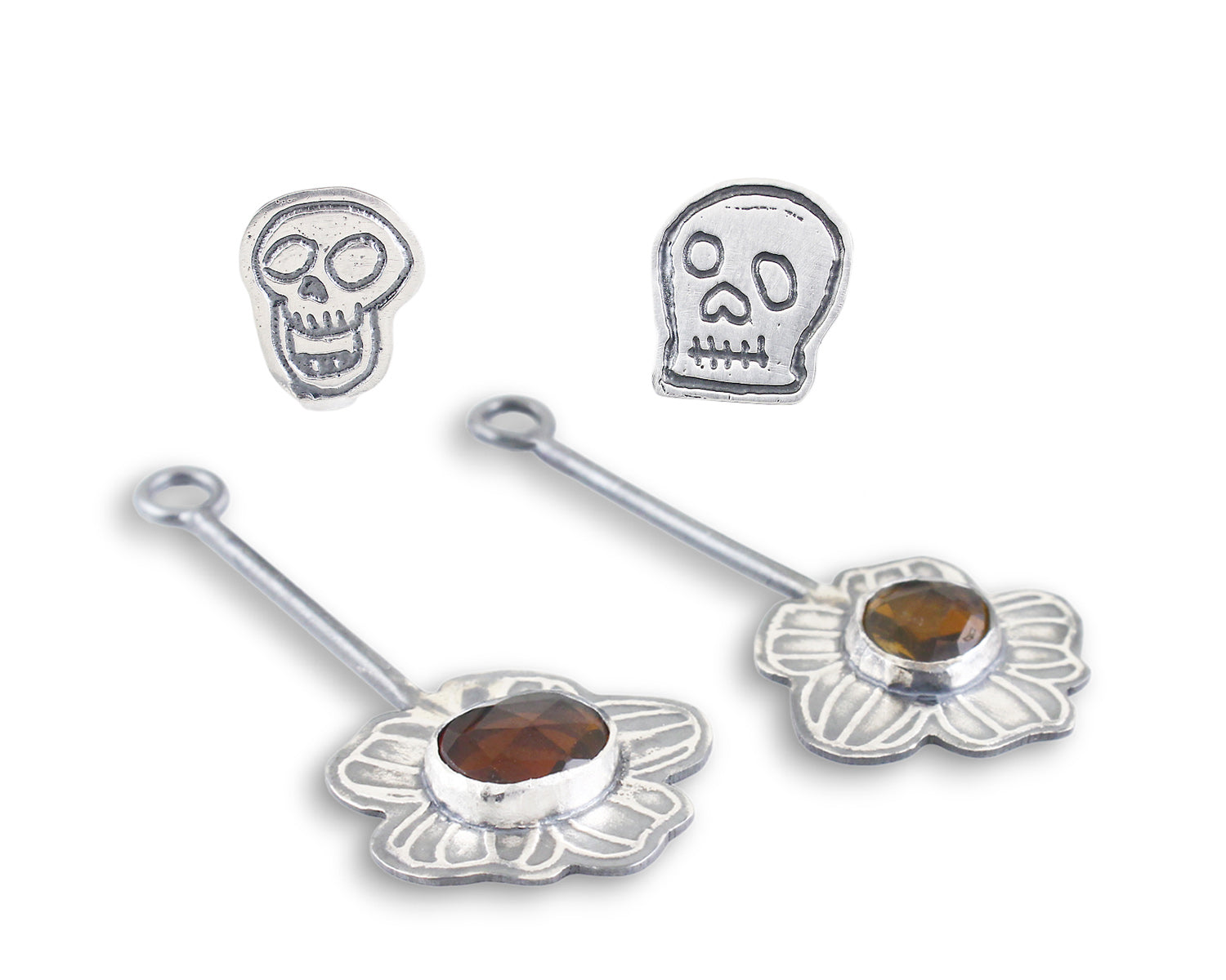 Skull Stud Earrings with Kinetic Tourmaline Wildfower - Laying Front View
