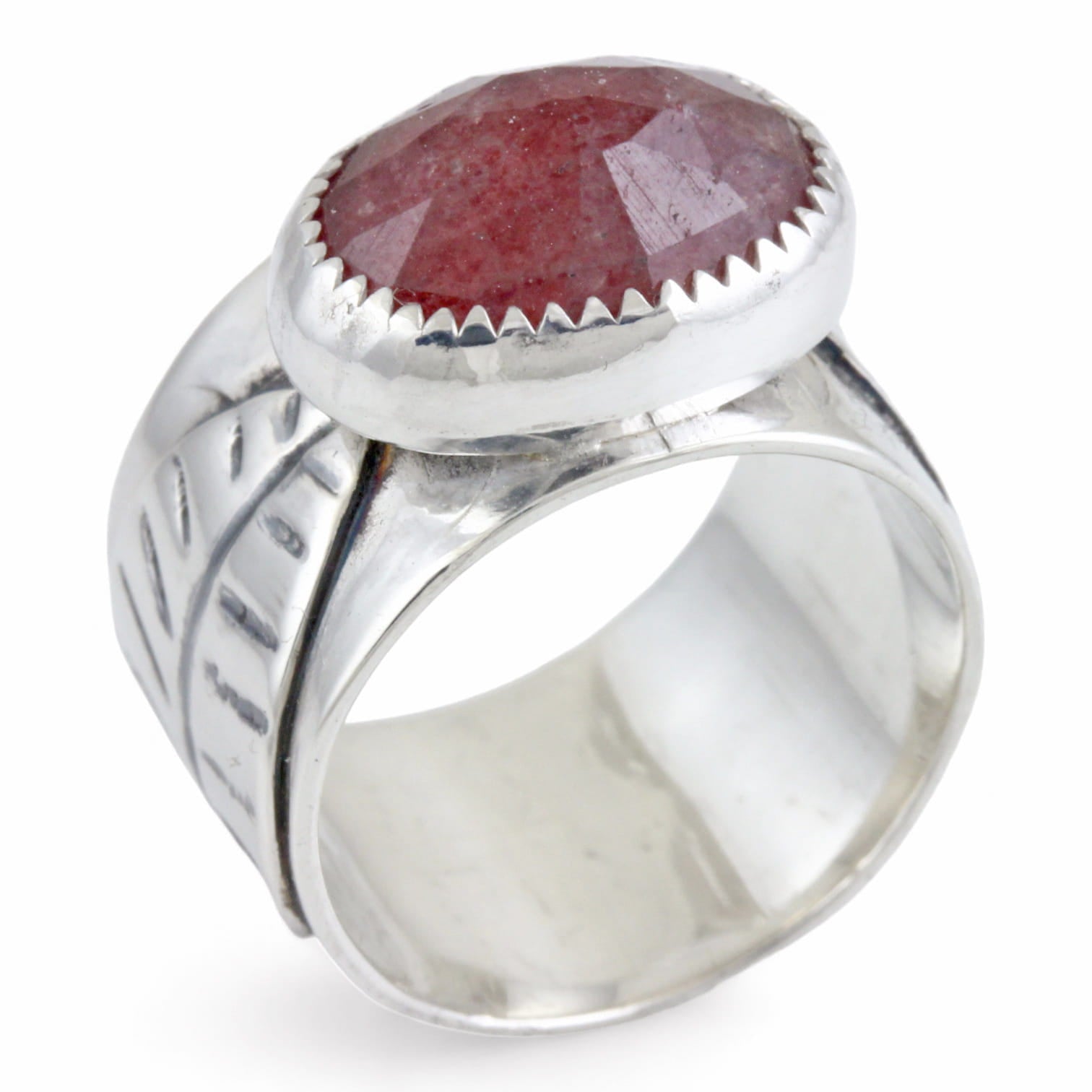 Silver ring with a pink oval stone on a white background