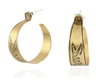 Handmade nu-gold brass hoop earrings with engraved Survive design on a white background.