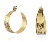 Handmade nu-gold brass hoop earrings with engraved Survive design on a white background.
