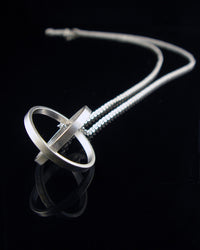 Silver necklace with a unique orb pendant on a black background