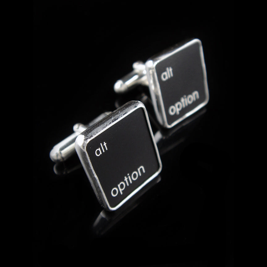 Cufflinks with 'alt option' text on black keys against a black background