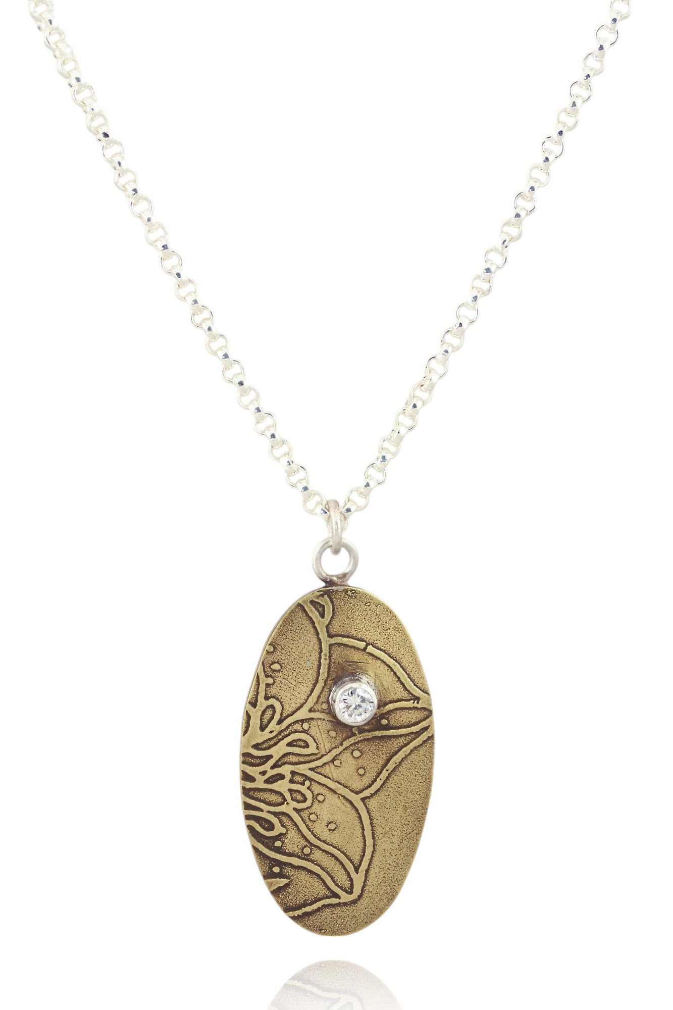 Pendant B: Brass botanical themed pendant with cubic zirconia (upper middle), on sterling chain.