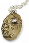 Pendant B: Brass botanical themed pendant with cubic zirconia (upper middle), on sterling chain.