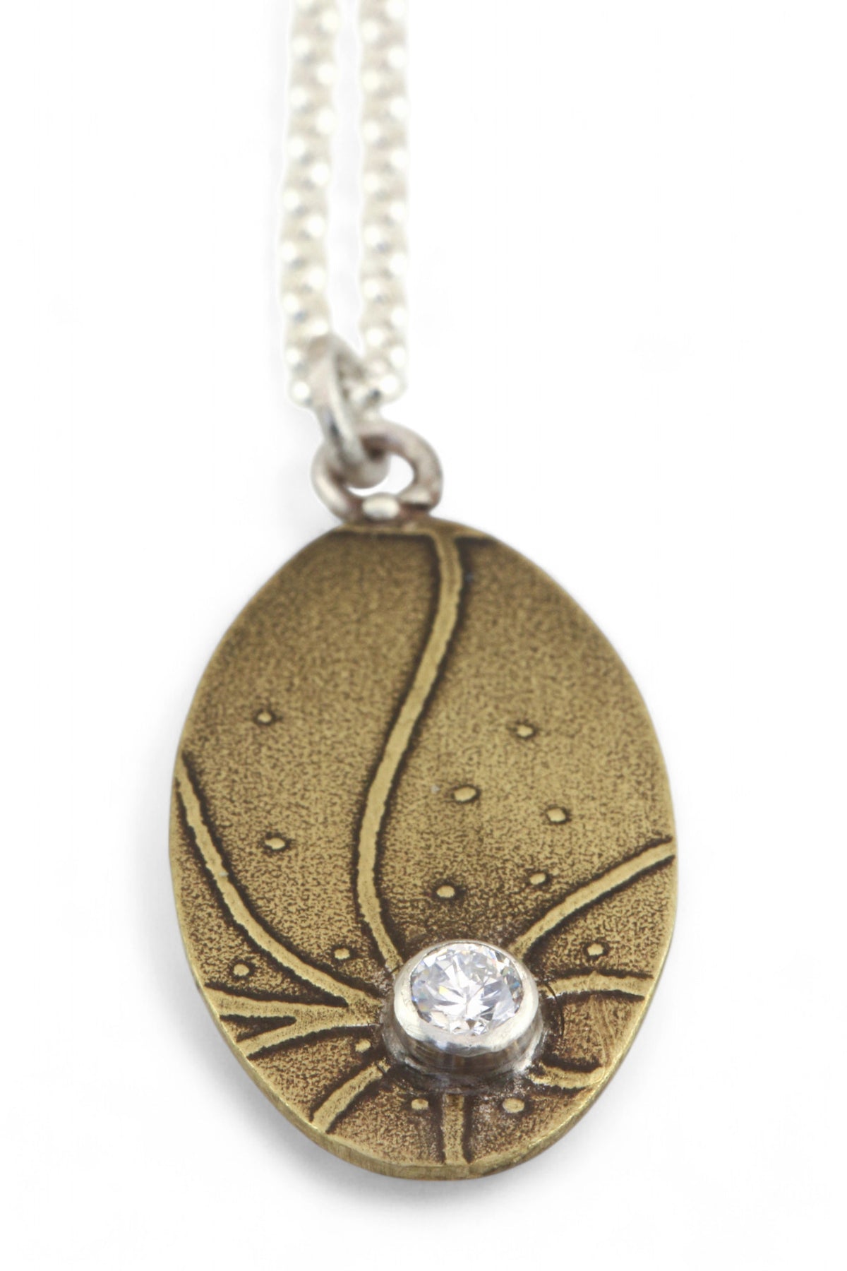 Pendant C: Brass botanical themed pendant with cubic zirconia (lower middle), on sterling chain.