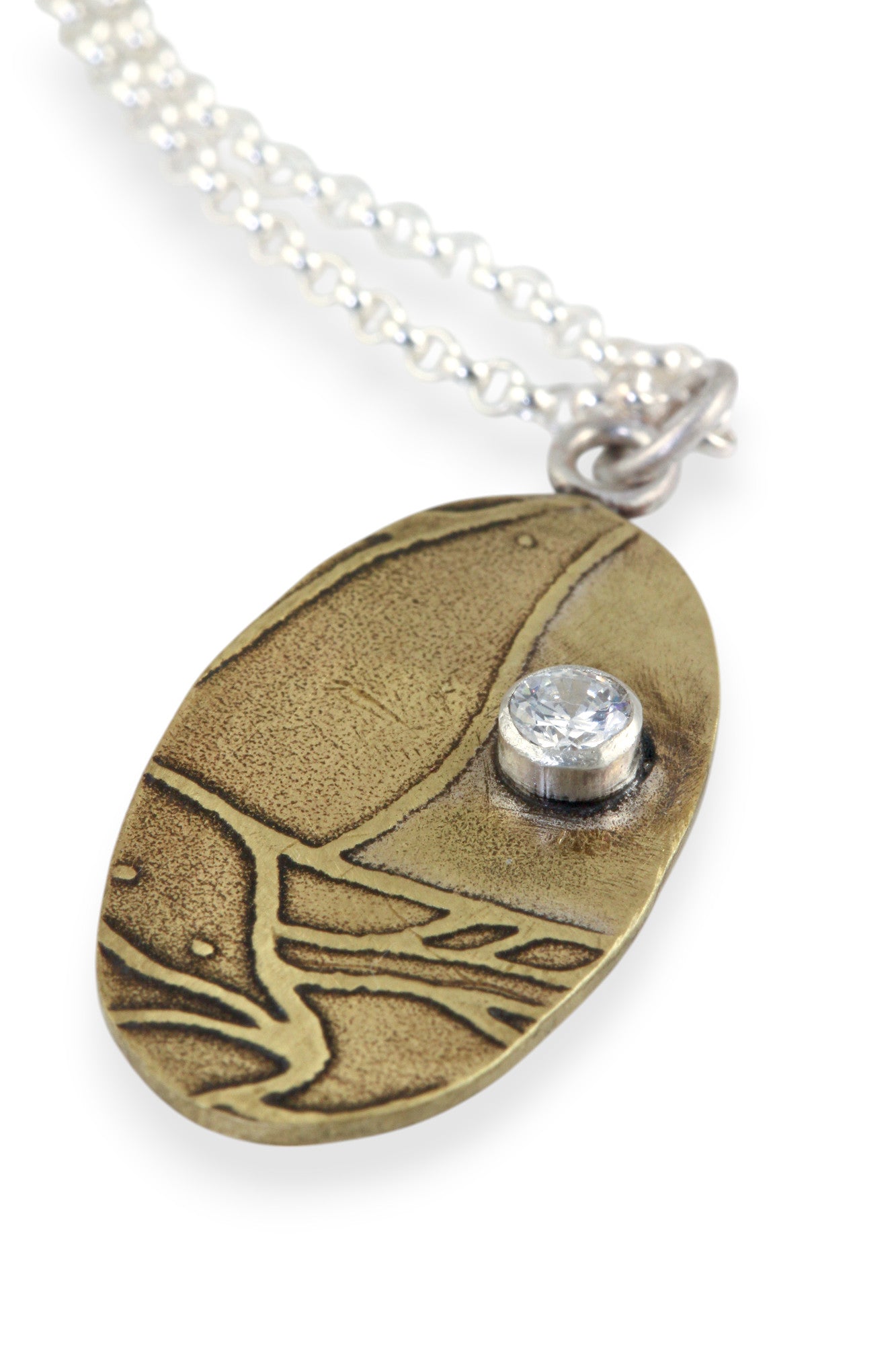 Pendant A: Brass botanical themed pendant with cubic zirconia (upper right), on sterling chain.