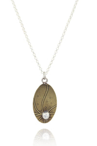 Pendant C: Brass botanical themed pendant with cubic zirconia (lower middle), on sterling chain.