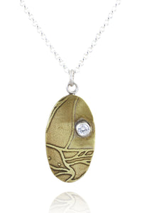 Pendant A: Brass botanical themed pendant with cubic zirconia (upper right), on sterling chain.